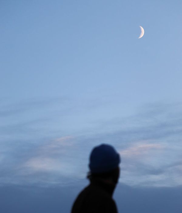 Person looking serene and calm outdoors with a blue frost color theme.